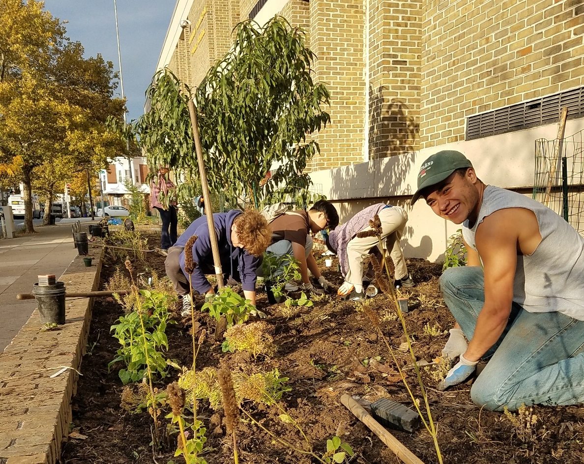 Volunteers plant fruit trees at a food forest in Philadelphia.